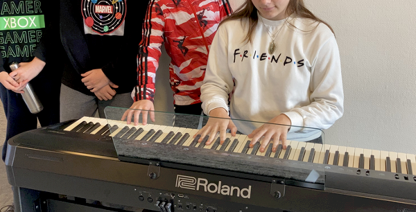 Students at the school piano